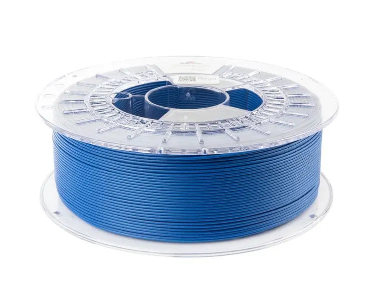 Bobine de filament bleu marine avec flasques transparentes, vue trois-quarts sur fond blanc