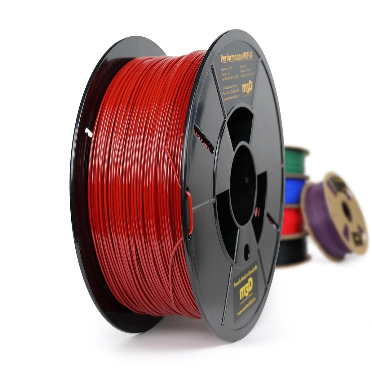Bobine de filament rouge en gros plan, avec d’autres bobines floues derrière sur fond blanc