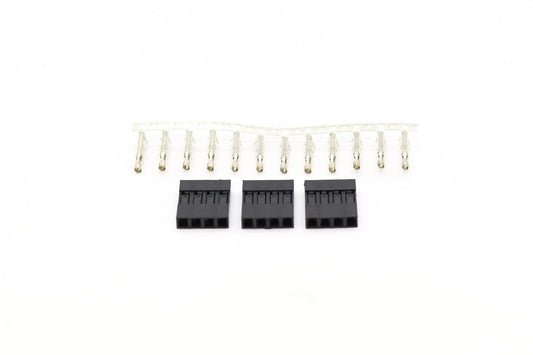 Sur fond blanc, une barrette de broches Dupont transparente et trois boîtiers noirs 4 broches alignés dessous