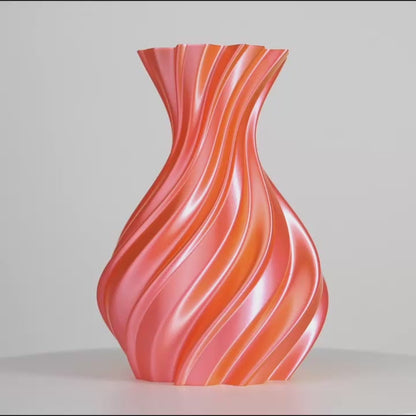 Vase ondulé rose et orange, centré sur fond gris