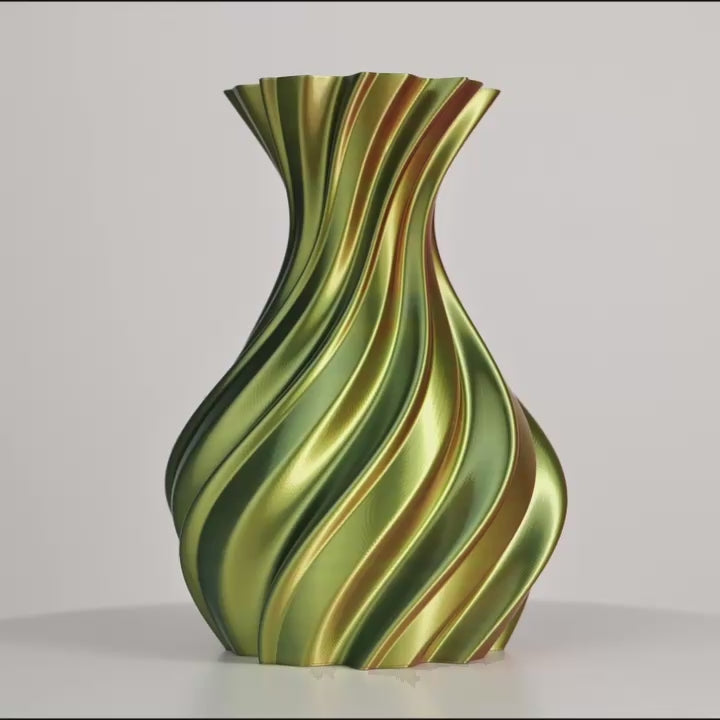 Vase ondulé vert, rouge et or sur fond gris, en vue de face centrée