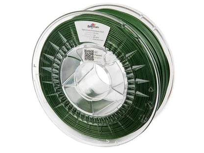 Bobine de filament vert émeraude dans une bobine transparente, vue de face sur fond blanc