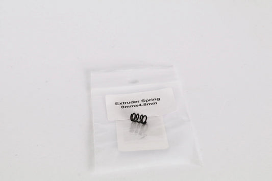 Petit sachet plastique transparent contenant un ressort noir, avec étiquette « Extruder Spring 8mmx4.8mm »