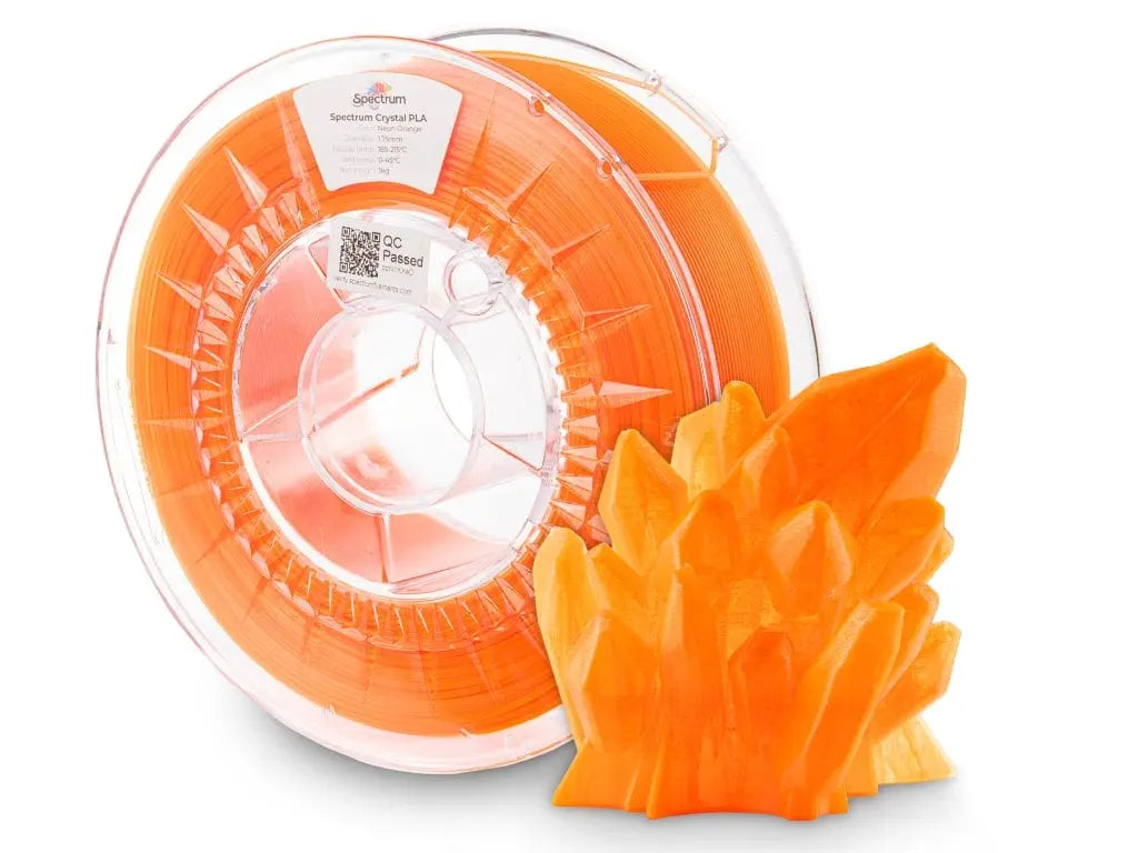 Bobine de filament orange transparent avec un objet imprimé en cristal orange au premier plan