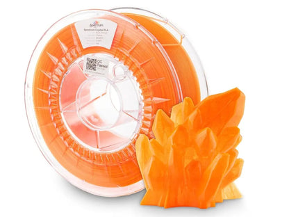 Bobine de filament orange transparent avec un objet imprimé en cristal orange au premier plan